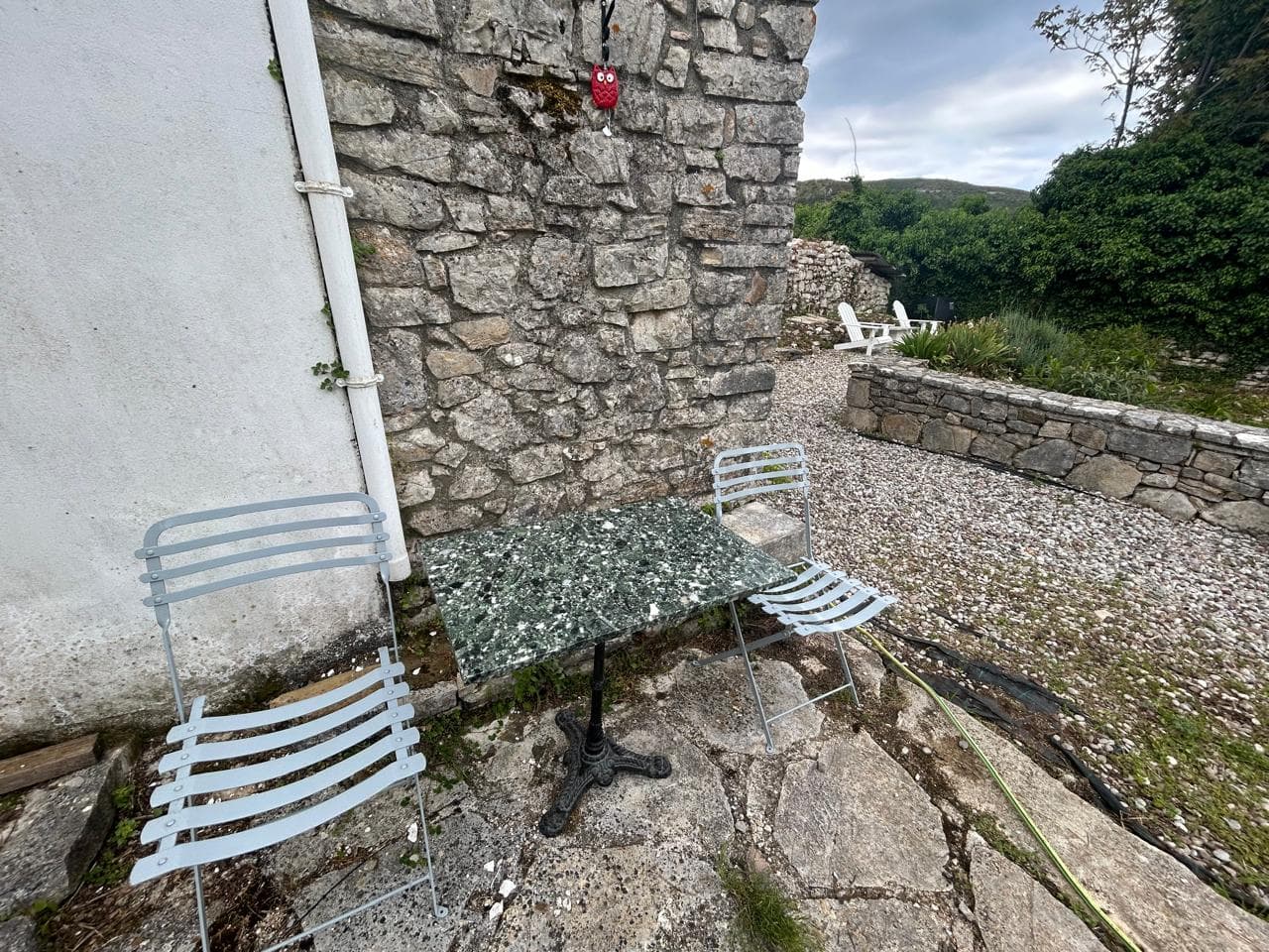 Stone courtyard with a bistro table in Old Peritheia