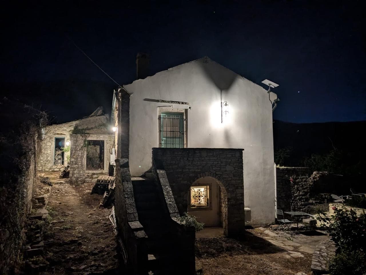 Φθαρμένος πέτρινος τοίχος του αρχοντικού με θέα στους λόφους της Κέρκυρας